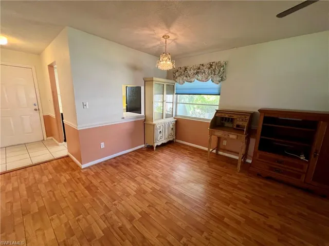 Unfurnished dining area with a notable chandelier and wood-type flooring