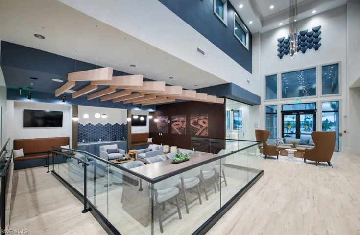 Community lobby featuring a towering ceiling and recessed lighting