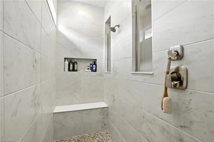 Full bathroom featuring a walk in tiled shower stall