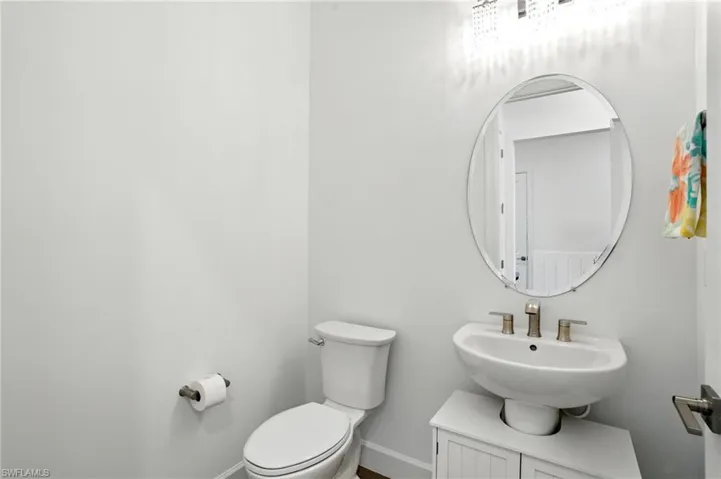 Half bathroom featuring toilet and a sink