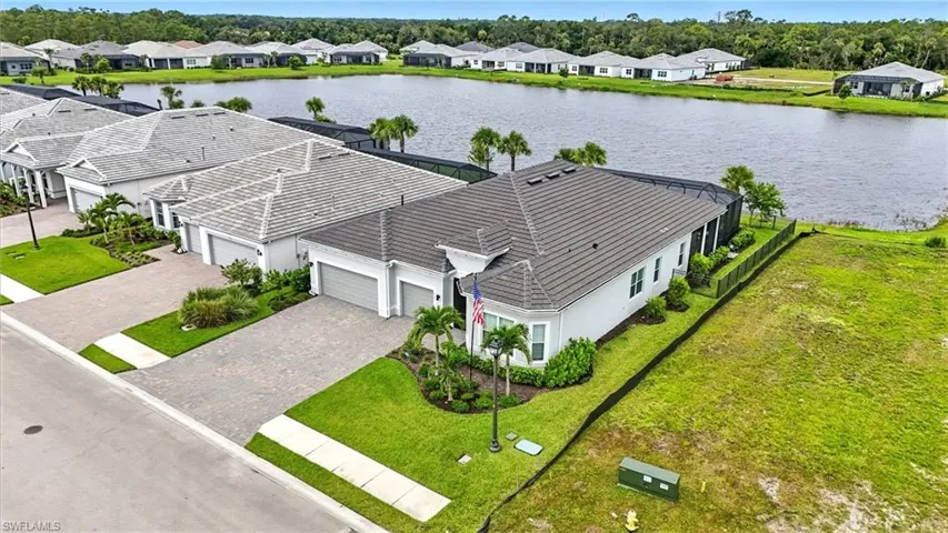 Aerial view of residential area featuring a large body of water