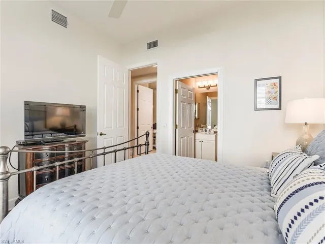 Bedroom with ceiling fan and connected bathroom