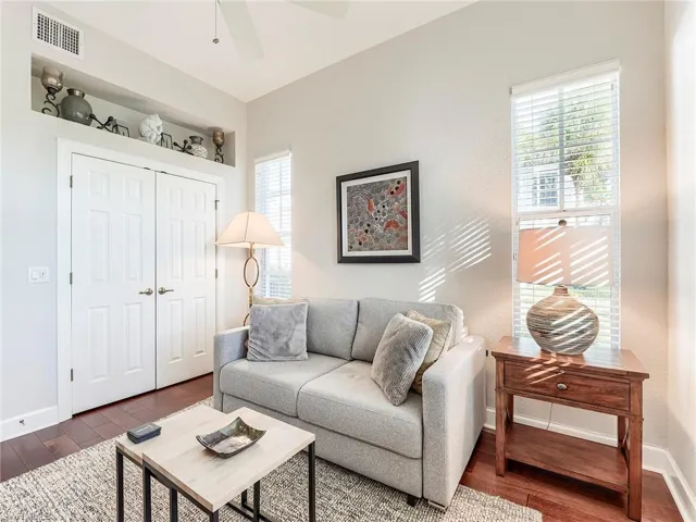 Living area featuring hardwood flooring and ceiling fan