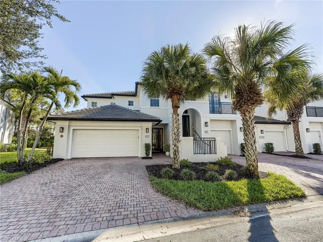 Mediterranean style house featuring decorative driveway, stucco siding, and an attached garage