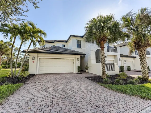 Mediterranean style home featuring decorative driveway, stucco siding, and an attached garage