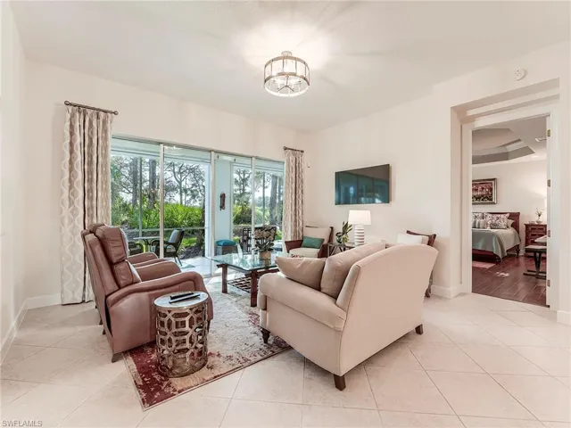 Living area featuring light tile patterned flooring and a chandelier
