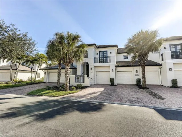 Mediterranean style home featuring a balcony, stucco siding, decorative driveway, and a garage