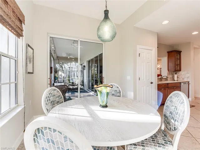 Dining space with light tile patterned flooring, healthy amount of natural light, a ceiling fan, a lanai, and recessed lighting