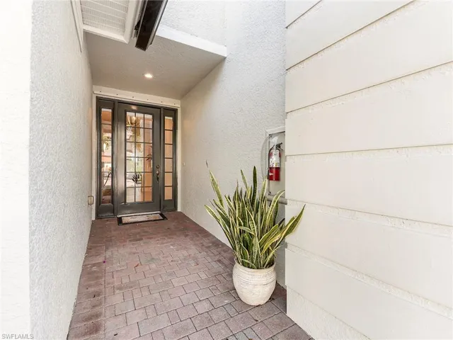 Entrance to home featuring stucco siding