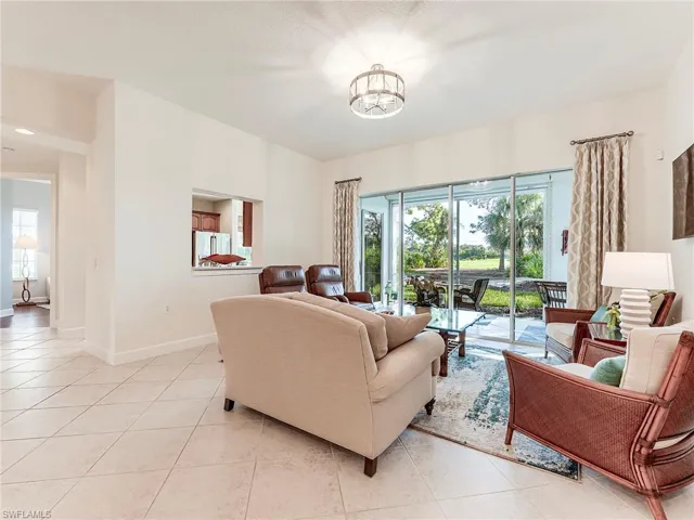 Living room with light tile patterned floors and baseboards