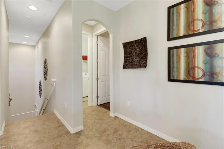 Hall with light tile patterned floors