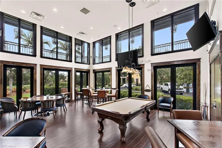 Game room with french doors, billiards, a healthy amount of sunlight, and a high ceiling
