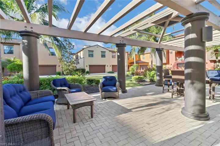 View of patio / terrace featuring an outdoor living space, a garage, and a pergola