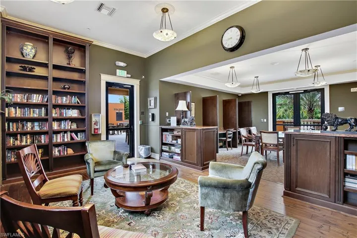 Sitting room featuring light wood-type flooring, crown molding, and french doors
