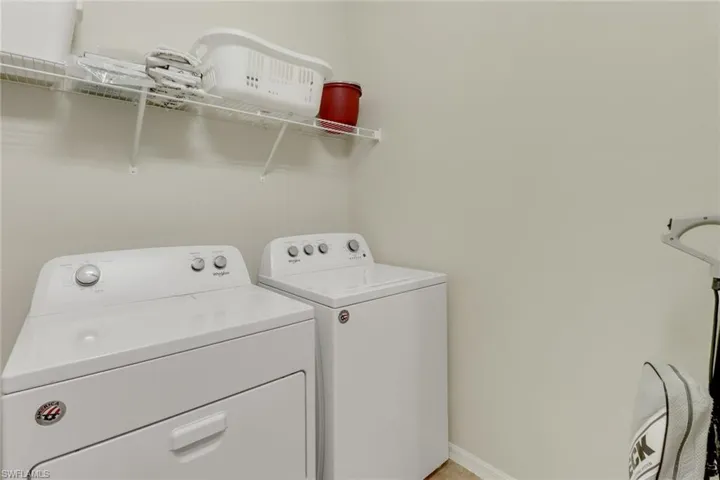Clothes washing area featuring separate washer and dryer
