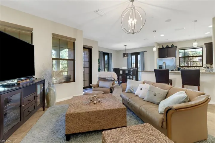 Tiled living room featuring a chandelier