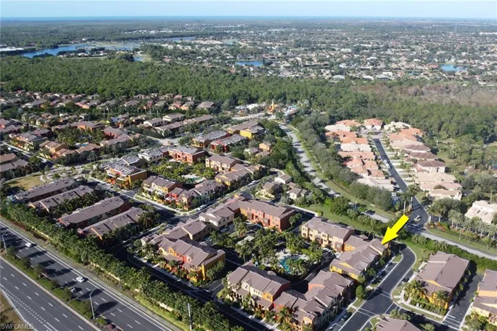 Birds eye view of property with a water view