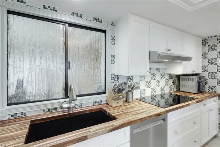 Kitchen window allows natural light to flow through from Atrium