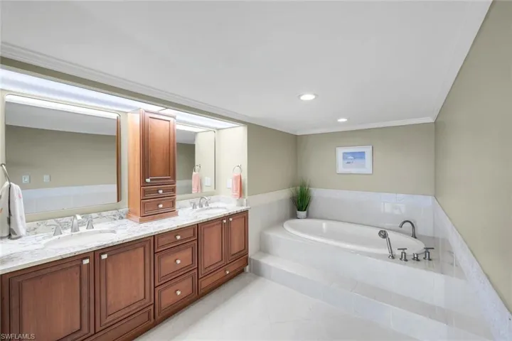 Jetted soaking tub, dual sinks, plenty of cabinet space, updated plumbing fixtures.  There is a Water closet that offers in addition, a single sink/vanity as well