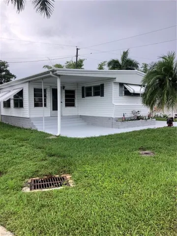Ranch-style home featuring a front lawn