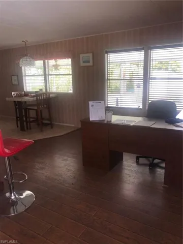 Unfurnished office featuring dark hardwood / wood-style floors