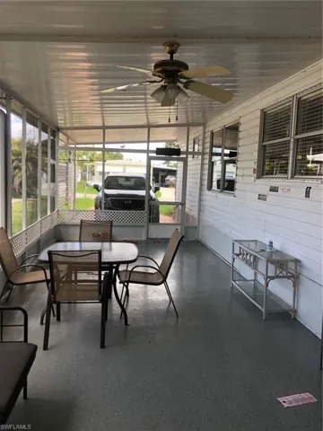 Sunroom featuring ceiling fan