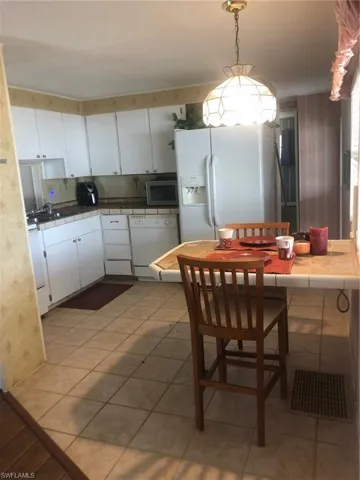 Dining room with sink and tile patterned floors