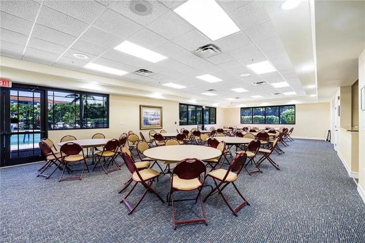 Carpeted dining area with a paneled ceiling