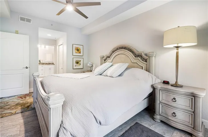 Bedroom with ensuite bath and ceiling fan