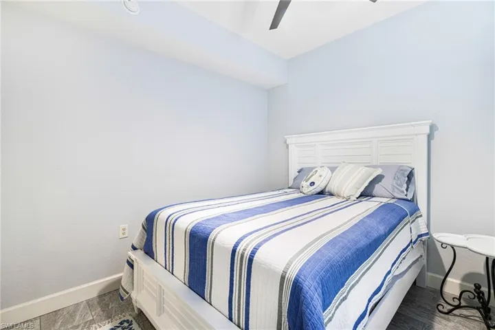 Bedroom featuring dark hardwood / wood-style floors and ceiling fan