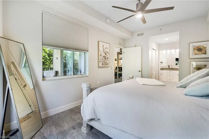 Bedroom featuring connected bathroom and ceiling fan
