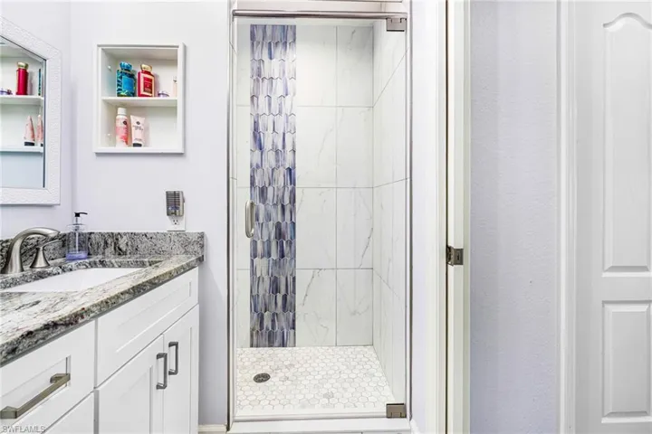 Bathroom with vanity and an enclosed shower