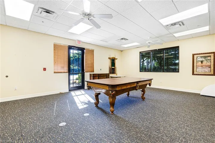 Rec room featuring carpet, ceiling fan, a paneled ceiling, and billiards