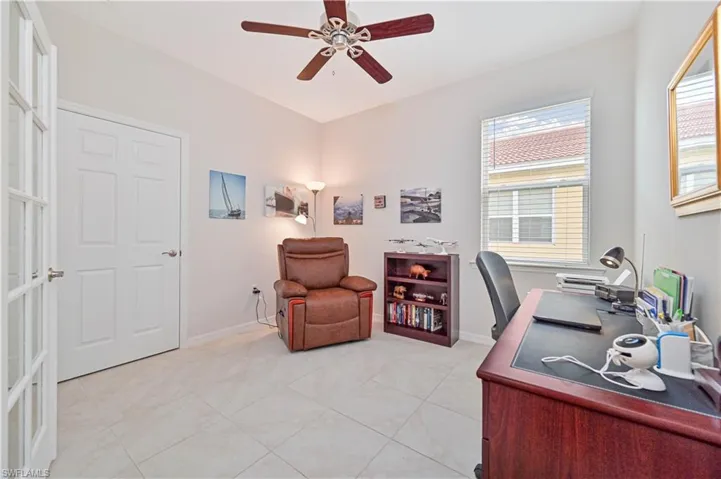 Office space featuring a ceiling fan and light tile patterned floors