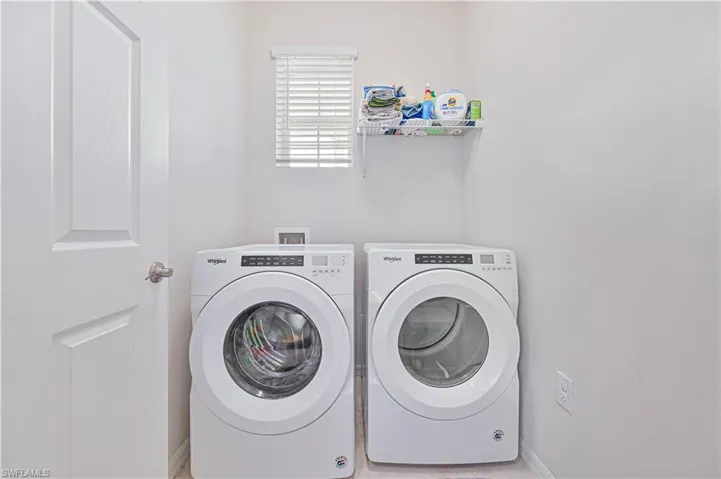 Washroom featuring separate washer and dryer and baseboards