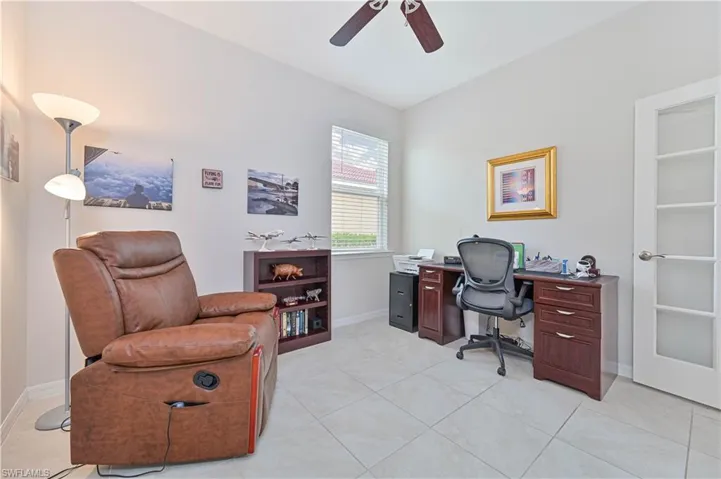 Office area featuring a ceiling fan and light tile patterned flooring