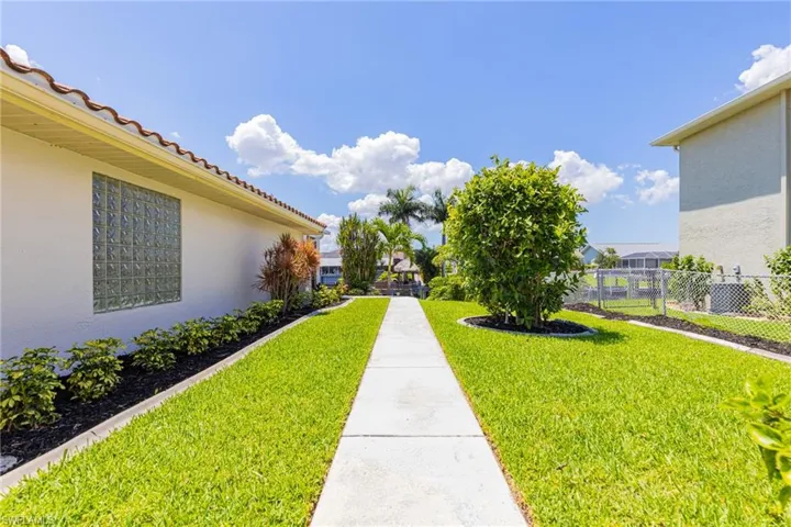 Fenced, Triple Lot with Sidewalk from Garage to back Lanai.