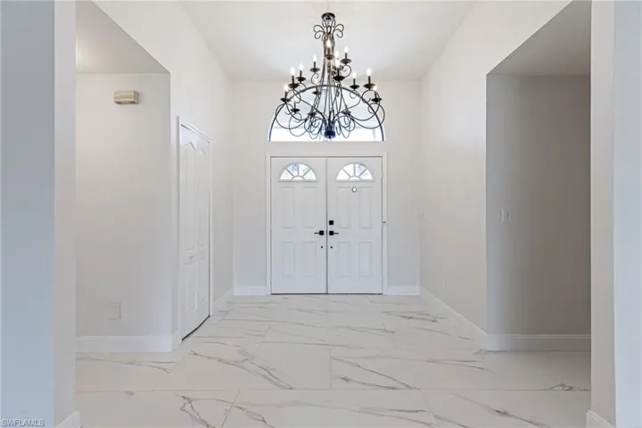 Double Entry Doors, beautiful Marble style porcelain Tile thorughout