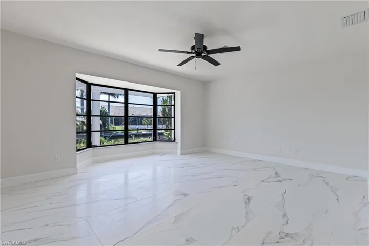Captivating Canal Views through Large Bay Window with Jalousie Windows