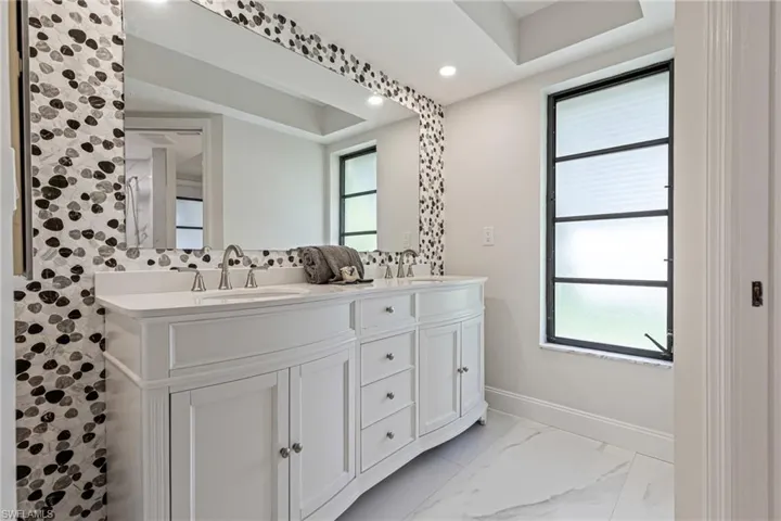Guest & Pool Bath NEW Double Vanity, Stone Accent Wall, and Large Closet. Offers Lanai Access.