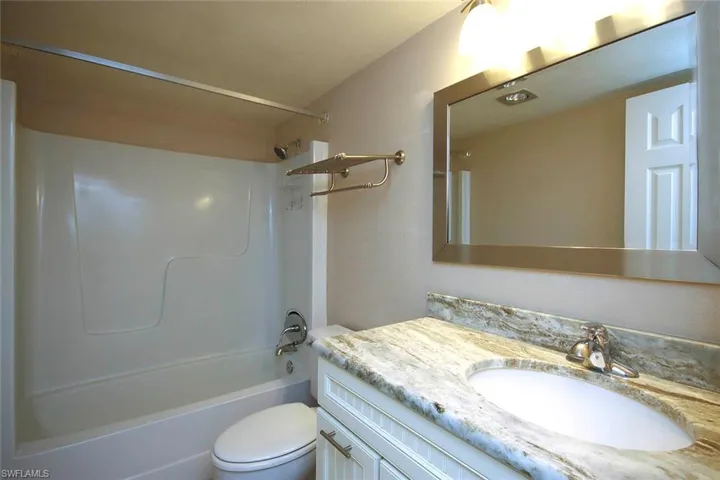 Bathroom featuring vanity, toilet, and shower / bath combination