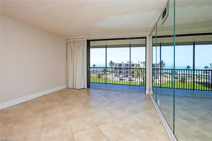 Empty room featuring baseboards and light tile floor