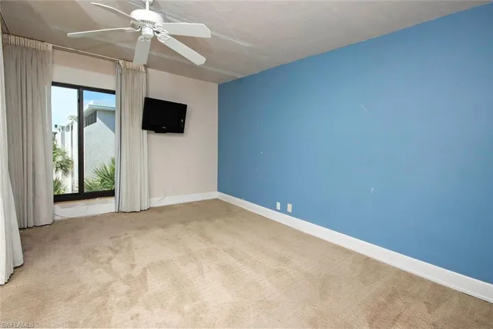 Empty room featuring ceiling fan, carpet flooring, and baseboards