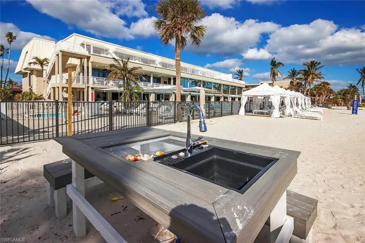 View of patio featuring a gazebo, an in-ground hot tub, and a sink