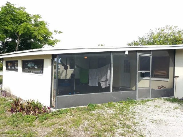 Rear view of house with a sunroom