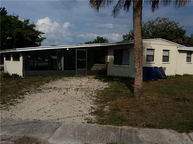View of front of house featuring a sunroom and stucco siding