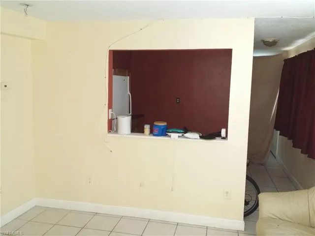 Unfurnished room featuring baseboards and light tile patterned floors