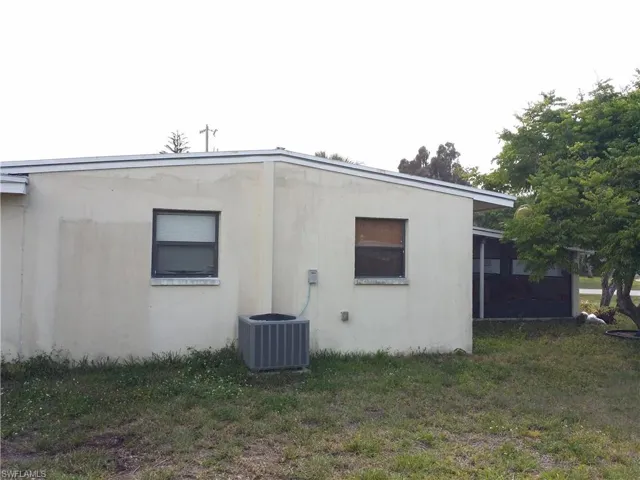 View of home's exterior featuring a yard and stucco siding