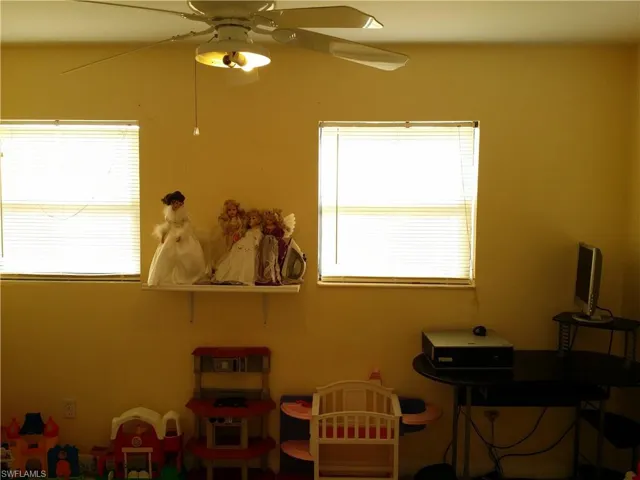 Game room featuring a ceiling fan and healthy amount of natural light