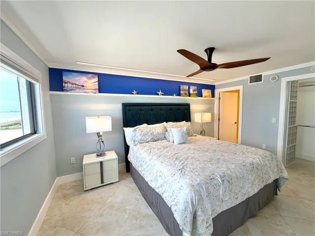 Recessed lighting with crown molding, ceiling fan, tile flooring, and built-in closet system
